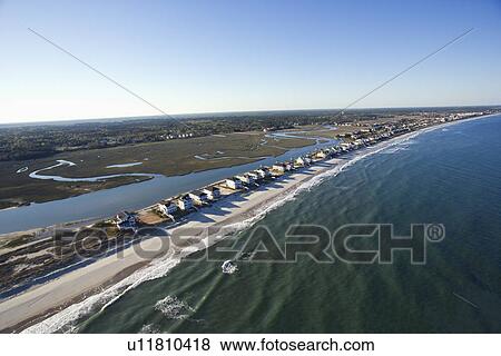 Stock Photo - Aerial view of houses in row on beachfront of Pawleys Island, South Carolina.. Fotosearch