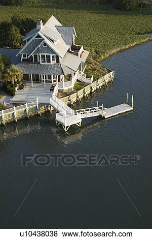 Stock Photo - Aerial view of waterfront home on Bald Head Island, North Carolina.. Fotosearch