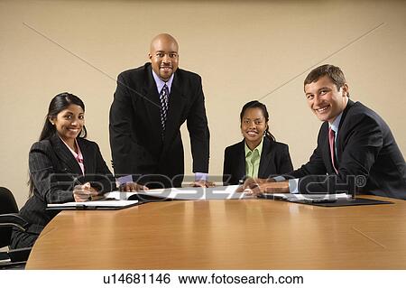 Stock Photograph - Businesspeople having meeting at conference table.. Fotosearch