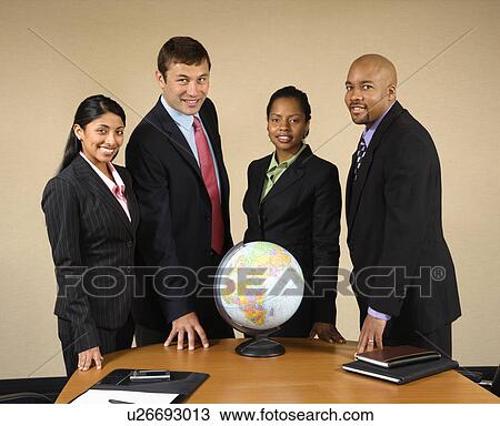 Corporate businesspeople standing around world globe smiling. View Large Photo Image Stock Image - Corporate businesspeople standing around world globe smiling.. Fotosearch