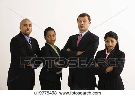 Stock Photo - Portrait of businessmen and businesswomen standing with arms crossed looking serious. Fotosearch