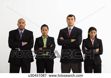 Stock Photo - Portrait of businessmen and businesswomen standing with arms crossed looking serious.. Fotosearch