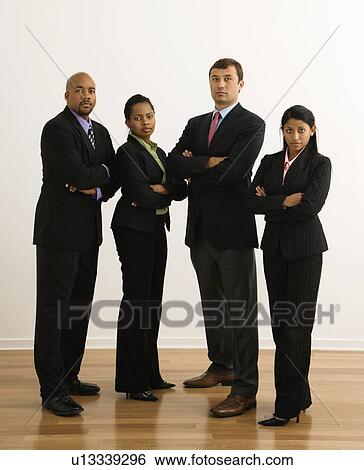 Portrait of businessmen and businesswomen standing with arms crossed looking serious. View Large Photo Image Stock Photograph - Portrait of businessmen and businesswomen standing with arms crossed looking serious.. Fotosearch