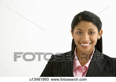 Stock Image - Portrait of smiling businesswoman against white background. Fotosearch