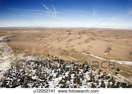Aerial landscape of snowy plains and dunes in Great Sand Dunes National Park, Colorado View Large Photo Image Stock Image - Aerial landscape of snowy plains and dunes in Great Sand Dunes National Park, Colorado. Fotosearch