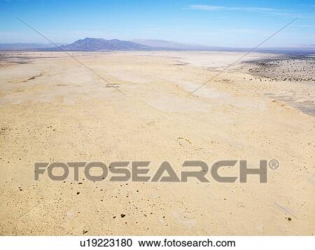 Aerial view of remote California desert with mountain range in background View Large Photo Image Stock Image - Aerial view of remote California desert with mountain range in background. Fotosearch