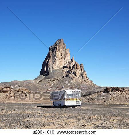 RV travelling toward rock formation in the desert of Monument Valley, Utah. View Large Photo Image Stock Image - RV travelling toward rock formation in the desert of Monument Valley, Utah.. Fotosearch