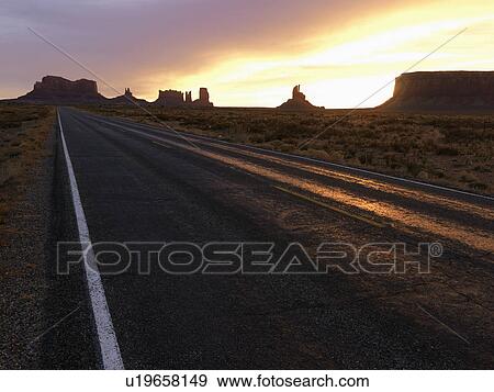 Scenic sunset landscape of highway in Monument Valley View Large Photo Image Stock Photo - Scenic sunset landscape of highway in Monument Valley. Fotosearch