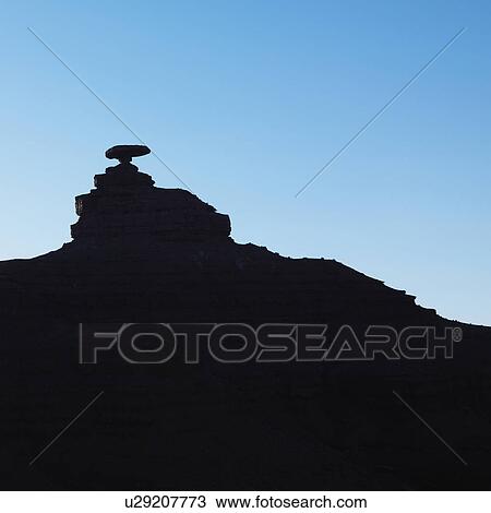 Stock Image - Silhouette of Mexican Hat rock formation in Utah.. Fotosearch