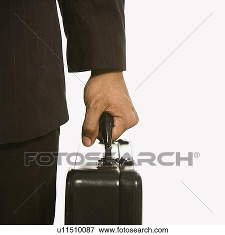 Stock Photo - African American businessman in suit holding briefcase.. Fotosearch