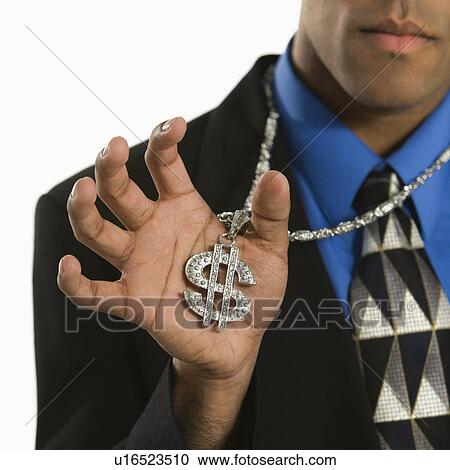 Stock Image - African American man wearing necklace with money sign.. Fotosearch