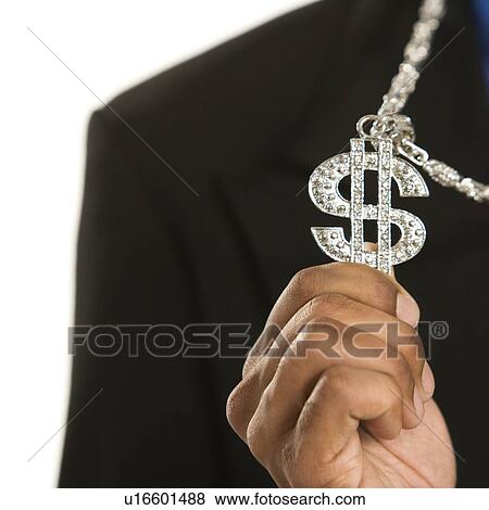 Stock Photo - African American man wearing necklace with money sign.. Fotosearch