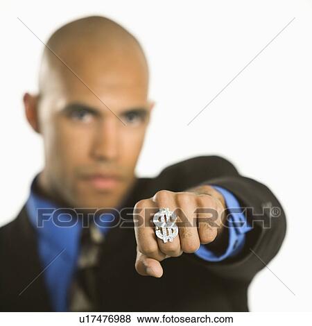 Stock Photo - African American man wearing ring with money sign.. Fotosearch