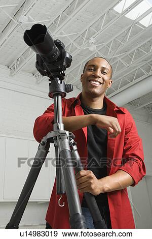 Stock Photo - African American young male adult looking at viewer smiling.. Fotosearch