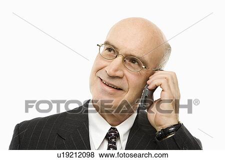Caucasian middle-aged businessman talking on cellphone smiling against white background. View Large Photo Image Stock Photo - Caucasian middle-aged businessman talking on cellphone smiling against white background.. Fotosearch