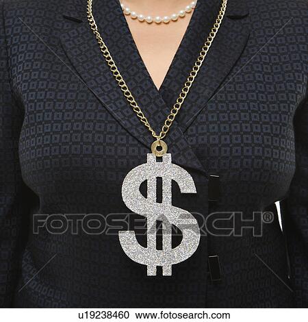 Stock Image - Close-up of Filipino middle-aged businesswoman wearing chain necklace with oversized dollar sign.. Fotosearch