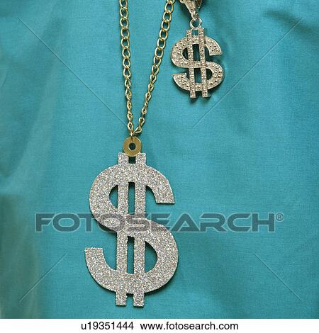 Picture - Close-up of green medical scrubs with two dollar sign necklaces.. Fotosearch