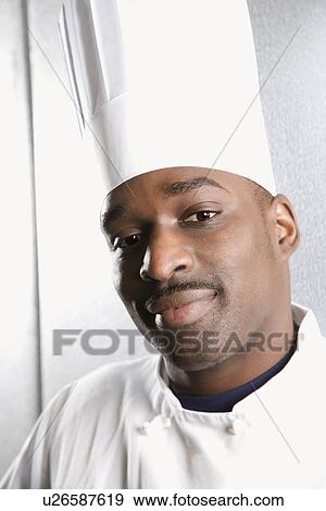 Head shot of African-American male chef wearing traditional uniform and toque looking at viewer. View Large Photo Image Stock Photo - Head shot of African-American male chef wearing traditional uniform and toque looking at viewer.. Fotosearch