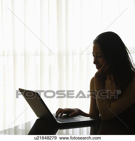 Silhouette of Taiwanese mid adult woman on laptop. View Large Photo Image Stock Photo - Silhouette of Taiwanese mid adult woman on laptop.. Fotosearch