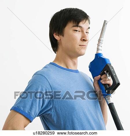 Asian young man holding gasoline pump nozzle. View Large Photo Image Stock Photo - Asian young man holding gasoline pump nozzle.. Fotosearch