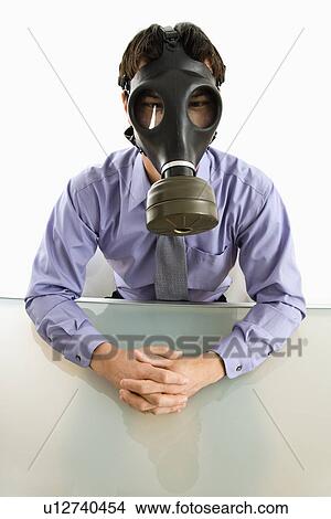 Businessman sitting in white room wearing gas mask View Large Photo Image Picture - Businessman sitting in white room wearing gas mask. Fotosearch