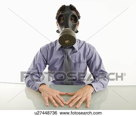 Businessman sitting in white room wearing gas mask. View Large Photo Image Stock Photograph - Businessman sitting in white room wearing gas mask.. Fotosearch