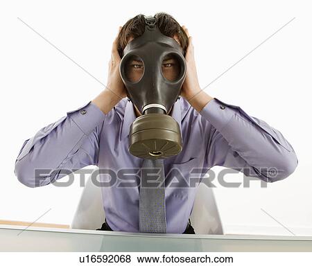 Businessman sitting wearing gas mask holding his hands over his ears. View Large Photo Image Stock Photo - Businessman sitting wearing gas mask holding his hands over his ears.. Fotosearch