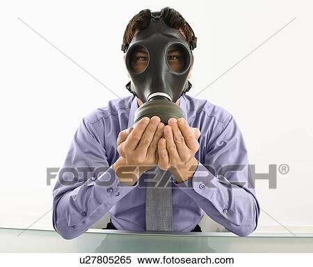 Businessman sitting wearing gas mask holding his hands over his mouth View Large Photo Image Stock Photography - Businessman sitting wearing gas mask holding his hands over his mouth. Fotosearch