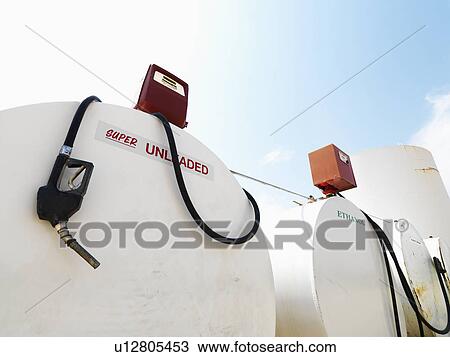 Stock Image - Fuel tanks labeled unleaded and ethanol and pumps.. Fotosearch