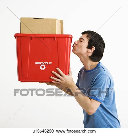 Portrait of Asian young man standing kissing recycling bin. View Large Photo Image Stock Image - Portrait of Asian young man standing kissing recycling bin.. Fotosearch