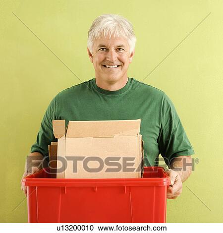 Portrait of smiling adult man holding recycling bin full of cardboard. View Large Photo Image Stock Image - Portrait of smiling adult man holding recycling bin full of cardboard.. Fotosearch