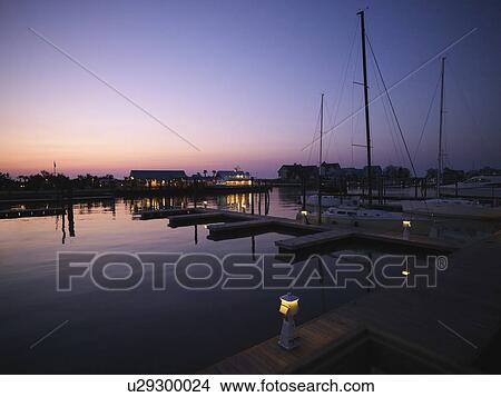 Ferry boat and sail boats at marina at dusk at Bald Head Island, North Carolina View Large Photo Image Picture - Ferry boat and sail boats at marina at dusk at Bald Head Island, North Carolina. Fotosearch