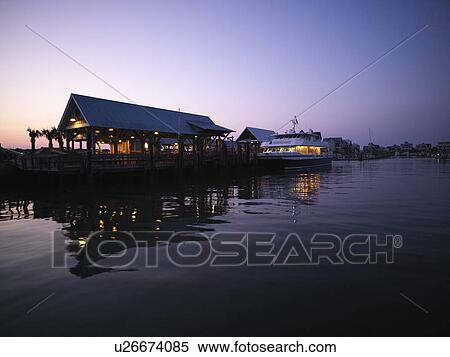 Ferry boat at dock at dusk at Bald Head Island, North Carolina View Large Photo Image Stock Photography - Ferry boat at dock at dusk at Bald Head Island, North Carolina. Fotosearch