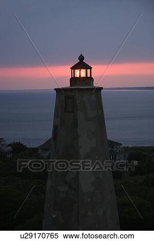 Stock Photography - Old Baldy lighthouse at dusk on Bald Head Island, North Carolina. Fotosearch