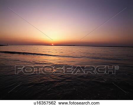 Sun setting over horizon of Atlantic ocean. View Large Photo Image Stock Image - Sun setting over horizon of Atlantic ocean.. Fotosearch
