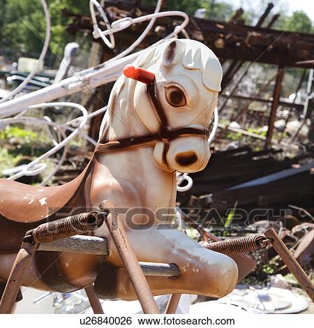Abandoned playground toy horse in junkyard View Large Photo Image Stock Photograph - Abandoned playground toy horse in junkyard. Fotosearch