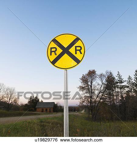 Circular yellow railroad grade crossing sign in rural setting. View Large Photo Image Stock Photograph - Circular yellow railroad grade crossing sign in rural setting.. Fotosearch
