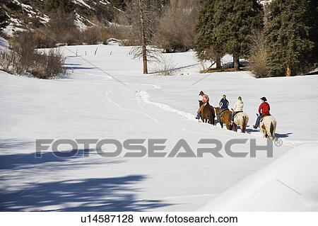 People horseback riding in snow View Large Photo Image Stock Photo - People horseback riding in snow . Fotosearch