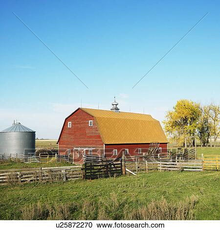 Stock Image - Red barn and fence in field.. Fotosearch