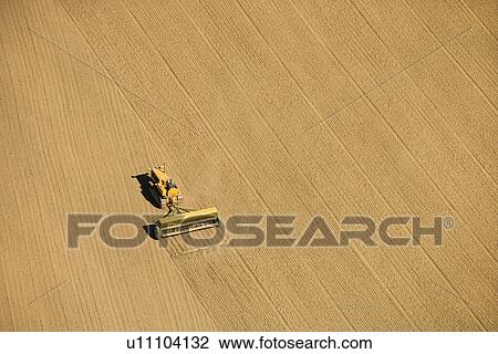 Aerial of farmer tilling crop field in farmland, USA View Large Photo Image Stock Image - Aerial of farmer tilling crop field in farmland, USA. Fotosearch