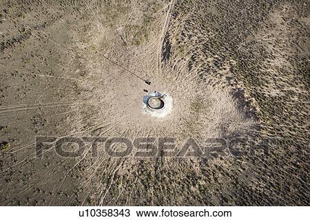 Aerial view of livestock watering pump in the middle of empty field. View Large Photo Image Stock Image - Aerial view of livestock watering pump in the middle of empty field.. Fotosearch