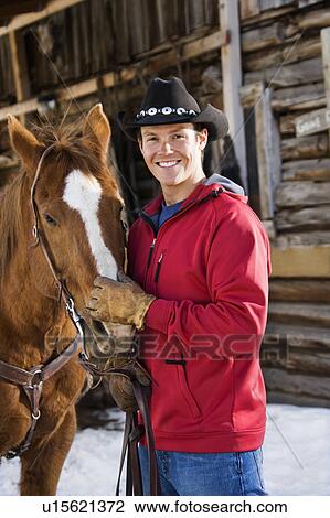 Cowboy petting horse View Large Photo Image Stock Image - Cowboy petting horse. Fotosearch