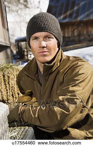 Stock Image - Man wearing hat outdoors in rural country. Fotosearch