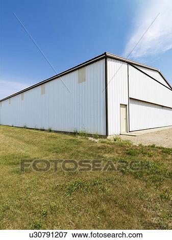 Stock Photo - Plain large aluminum building in rural setting. Fotosearch