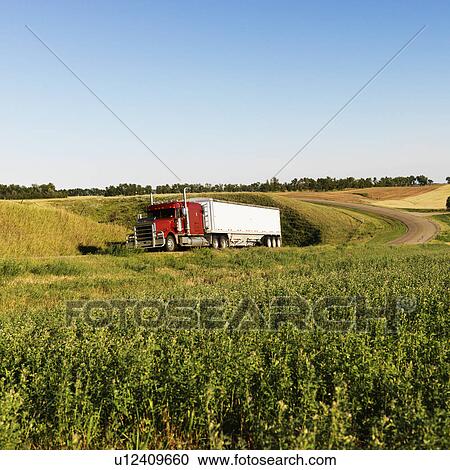 Semi tractor truck on rural road with green plants on shoulder View Large Photo Image Stock Image - Semi tractor truck on rural road with green plants on shoulder. Fotosearch