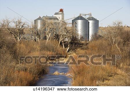 Storage silos by creek in rural setting. View Large Photo Image Stock Photo - Storage silos by creek in rural setting.. Fotosearch