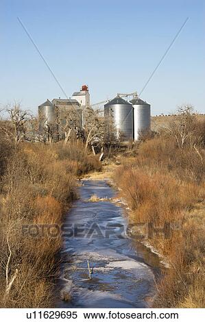 Storage silos by creek in rural setting. View Large Photo Image Stock Photography - Storage silos by creek in rural setting.. Fotosearch