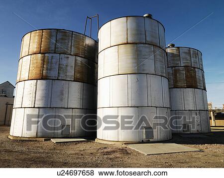 Stock Photo - Three silos in rural setting.. Fotosearch