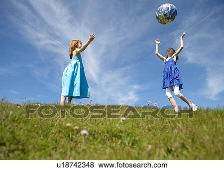 2 young girls throwing inflatable globe View Large Photo Image Stock Photo - 2 young girls throwing inflatable globe. Fotosearch
