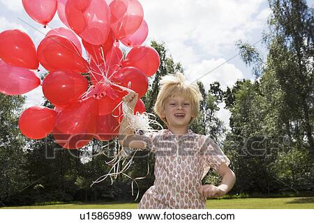 Boy holding bunch of red balloons View Large Photo Image Stock Photo - Boy holding bunch of red balloons. Fotosearch